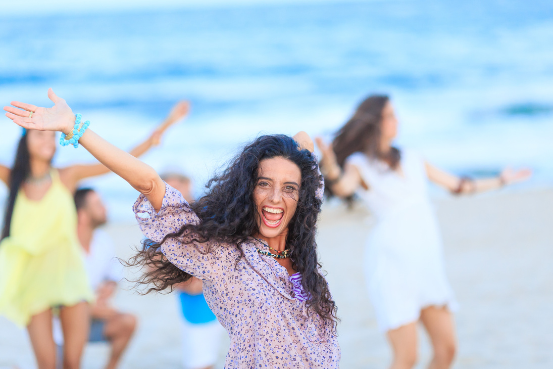 Young women dancing on beach